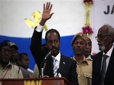 Somalia's newly elected President Hassan Sheikh Mohamud waves after winning the election, in Mogadishu